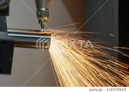 Close up scene the fiber laser cutting machine cut the stainless steel tube and sparkling light. Close up scene the fiber laser cutting machine cut the stainless steel tube and sparkling light. 116570910