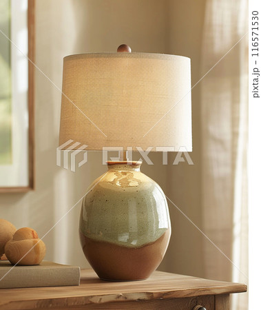 Handmade ceramic table lamp using glazed pottery material. Lampshade is made of fabric. 116571530