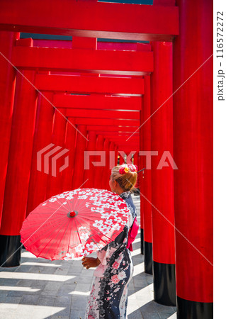 Asian girl in kimono and umbrella in Japanese theme park Hinoki Land in Chai Prakan District, Chiang 116572272