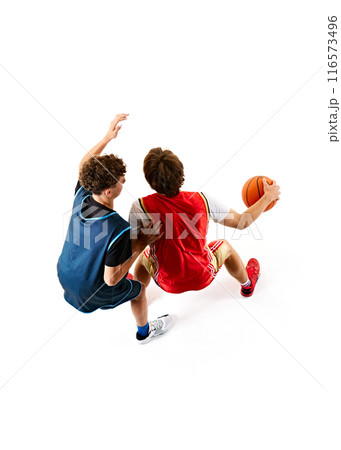 Two young athletes showcasing their skills and determination on court, during intense game against white studio background. Aerial view. 116573496