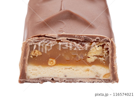 Chocolate bar in a section isolated on a white background. Sliced crunchy chocolate sweet bar.  116574021