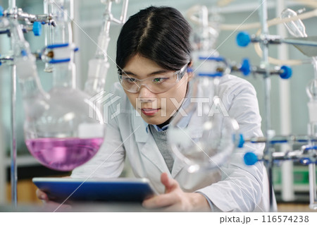 Looking at purple liquid in test tube 116574238