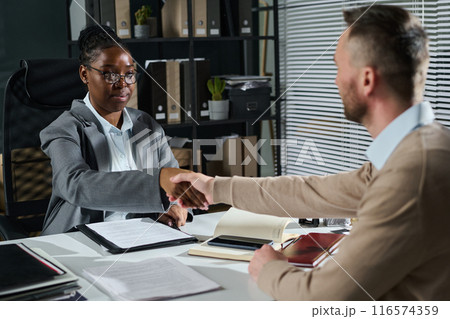 Solicitor shaking hand of male client 116574359