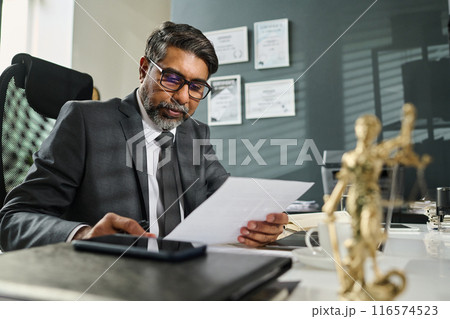 Looking through financial paper document 116574523