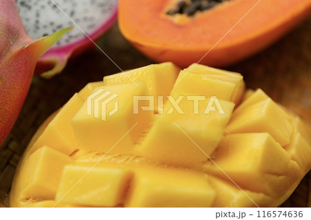 Delicious Exotic Tropic Fruits Top View on Wicker Mat Background Delicious Exotic Tropic Fruits Top View on Wicker Mat Background 116574636