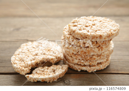 A stack of dietary round, airy, crisp buckwheat crispbread on grey wooden background 116574809
