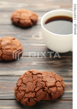Cup of coffee and chocolate cookies on brown wooden table Cup of coffee and chocolate cookies on brown wooden table 116574832