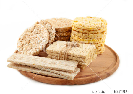 Various types of healthy whole grain crispbreads on cutting board isolated on white background. 116574922