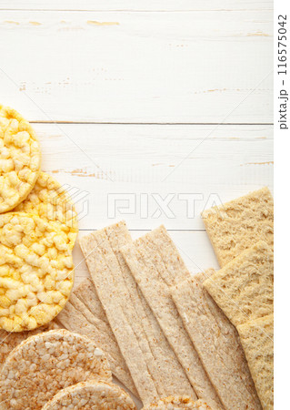 Various types of healthy whole grain crispbreads on white wooden background. Vertical foto 116575042