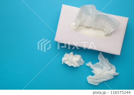 Box with paper tissues on blue background 116575244