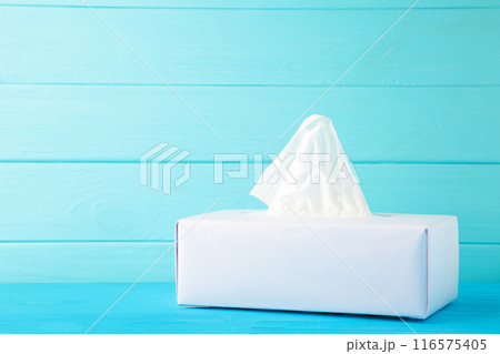 Box with paper tissues on blue background 116575405