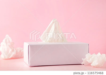 Box with paper tissues and used crumpled napkins on pink background Box with paper tissues and used crumpled napkins on pink background 116575468