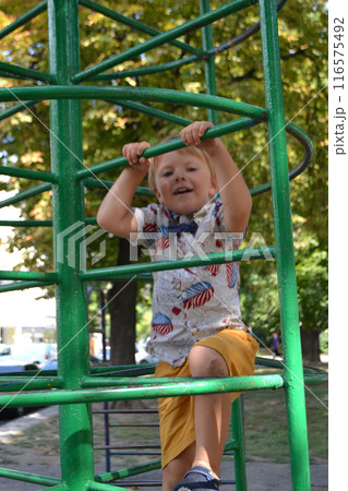 Little children run around and play in the playground. 116575492