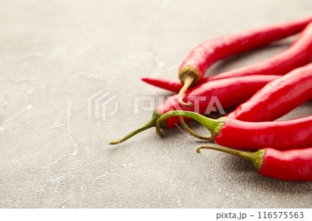 Red hot chili peppers on grey background with copy space 116575563