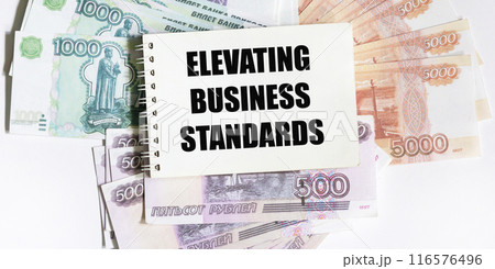 Notepad with the text INCREASING BUSINESS STANDARDS in Russian rubles Notepad with the text INCREASING BUSINESS STANDARDS in Russian rubles 116576496