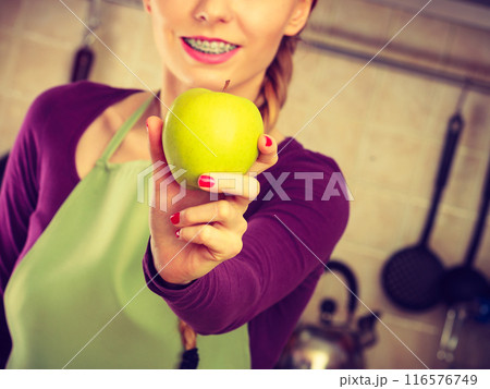 Woman young housewife in kitchen with apple fruit Woman young housewife in kitchen with apple fruit 116576749