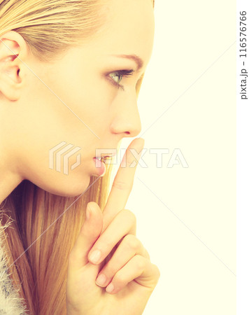 Young blonde woman making silence gesture 116576766
