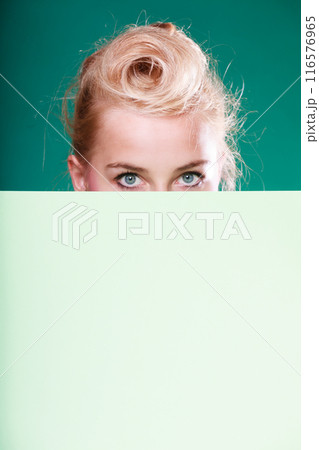 Pin up woman eyes behind white sign Pin up woman eyes behind white sign 116576965