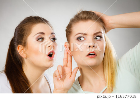 Two women telling gossip Two women telling gossip 116577019