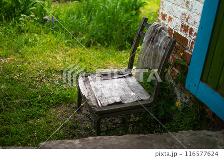 An old chair in an abandoned house An old chair in an abandoned house 116577624