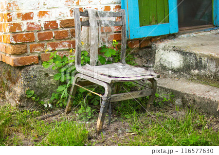 An old chair in an abandoned house 116577630