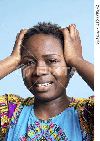 African american female model is feeling unwell and exhausted, experiencing tension and flu symptoms on camera. Desperate sick adult suffers from unpleasant headache in studio. African american female model is feeling unwell and exhausted, experiencing tension and flu symptoms on camera. Desperate sick adult suffers from unpleasant headache in studio. 116578942