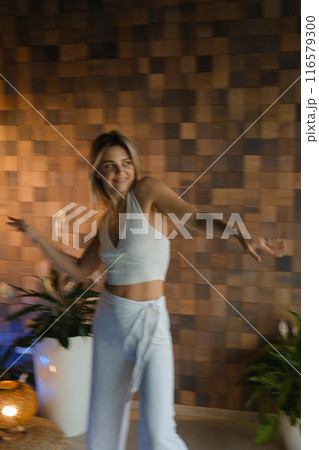Girl doing meditating bodywork at the gym . Girl doing yoga in the gym 116579300