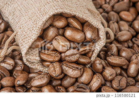 Natural roasted coffee beans in a bag as a background. Natural roasted coffee beans in a bag as a background. 116580121