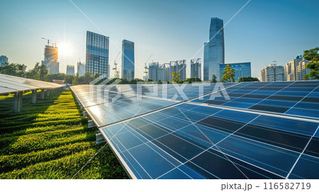 An expansive solar farm stretches out under the clear blue sky, showcasing rows of photovoltaic 116582719