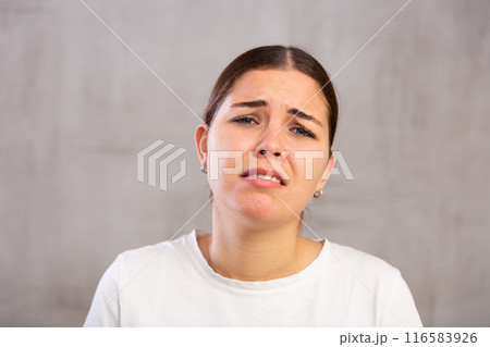 Close-up portrait of young woman with sad expression on face 116583926