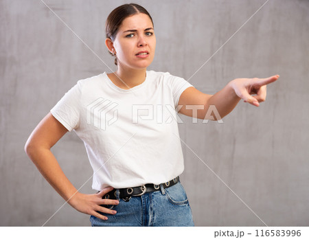 Angry young woman shouting aggressively 116583996