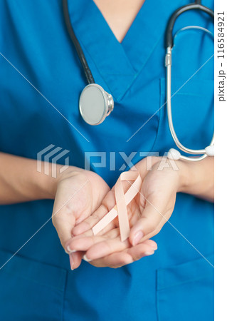 Doctor holding Peach Ribbon for September Uterine Cancer Awareness month. Uterus and Ovaries, Endometriosis, Hysterectomy, Uterine fibroids, Reproductive, Healthcare and World cancer day concept 116584921
