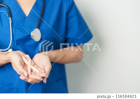 Doctor holding Peach Ribbon for September Uterine Cancer Awareness month. Uterus and Ovaries, Endometriosis, Hysterectomy, Uterine fibroids, Reproductive, Healthcare and World cancer day concept 116584923