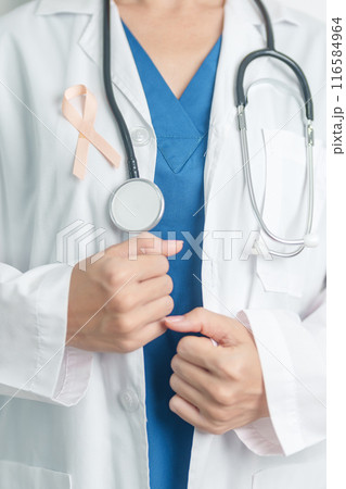 Doctor holding Peach Ribbon for September Uterine Cancer Awareness month. Uterus and Ovaries, Endometriosis, Hysterectomy, Uterine fibroids, Reproductive, Healthcare and World cancer day concept Doctor holding Peach Ribbon for September Uterine Cancer Awareness month. Uterus and Ovaries, Endometriosis, Hysterectomy, Uterine fibroids, Reproductive, Healthcare and World cancer day concept 116584964