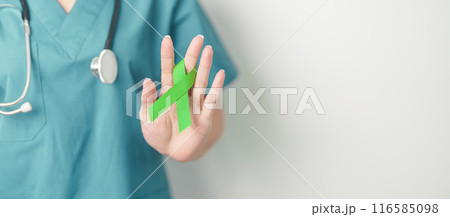 Doctor with green Ribbon for world Lymphoma Awareness September month, world Mental Health Day, Liver, Gallbladders, bile duct, cervical, kidney Cancer. Healthcare and world cancer day concept Doctor with green Ribbon for world Lymphoma Awareness September month, world Mental Health Day, Liver, Gallbladders, bile duct, cervical, kidney Cancer. Healthcare and world cancer day concept 116585098