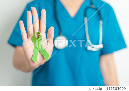 Doctor with green Ribbon for world Lymphoma Awareness September month, world Mental Health Day, Liver, Gallbladders, bile duct, cervical, kidney Cancer. Healthcare and world cancer day concept Doctor with green Ribbon for world Lymphoma Awareness September month, world Mental Health Day, Liver, Gallbladders, bile duct, cervical, kidney Cancer. Healthcare and world cancer day concept 116585099