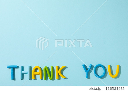 The word "thank you" from colored plasticine on a blue background. 116585483