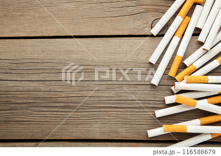 Cigarettes on grey wooden background. Top view. Cigarettes on grey wooden background. Top view. 116586679