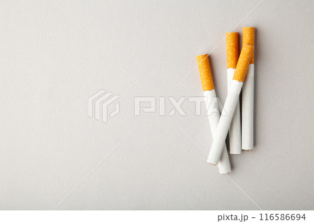 Cigarettes on grey background with copy space. Cigarettes on grey background with copy space. 116586694