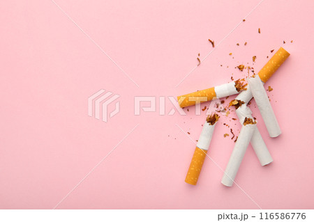 Broken cigarettes on pink background with copy space. 116586776