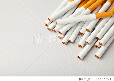 Cigarettes on a grey background with copy space. Cigarettes on a grey background with copy space. 116586794