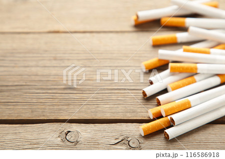 Cigarettes on grey wooden background. Top view. Cigarettes on grey wooden background. Top view. 116586918