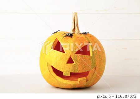 Halloween pumpkin with spiders on white background with copy space 116587072