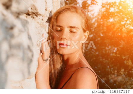 Woman summer travel. Happy tourist enjoy taking selfie photo outdoors for memories. Woman traveler posing in summer park on sunset, sharing travel adventure journey 116587117