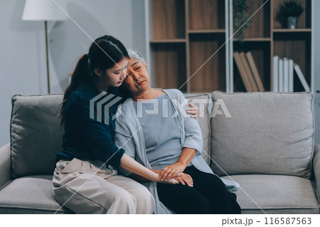 Sad teen granddaughter hugging depressed mature grandmother, giving support, help, comforting, consoling granny. Teenage daughter girl and middle aged mother going through family problems 116587563