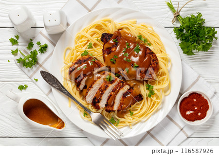 Chicken Lazone with sauce and linguine on plate 116587926