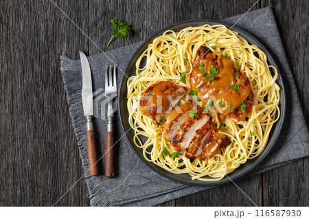 Chicken Lazone with sauce and linguine on plate Chicken Lazone with sauce and linguine on plate 116587930