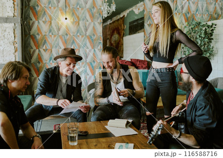 Group of gen X and gen Y musicians spending time in abandoned house working together on rock music album 116588716