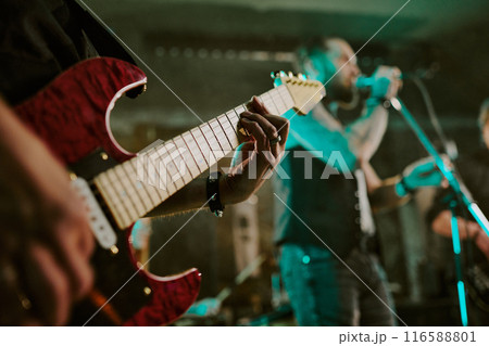 Closeup of hands of unrecognizable guitarist playing in rock band on stage in nightclub Closeup of hands of unrecognizable guitarist playing in rock band on stage in nightclub 116588801