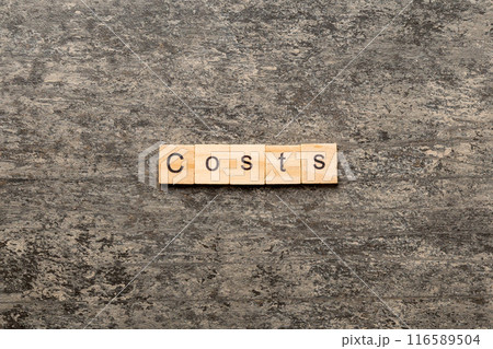 costs word written on wood block. costs text on cement table for your desing, concept 116589504